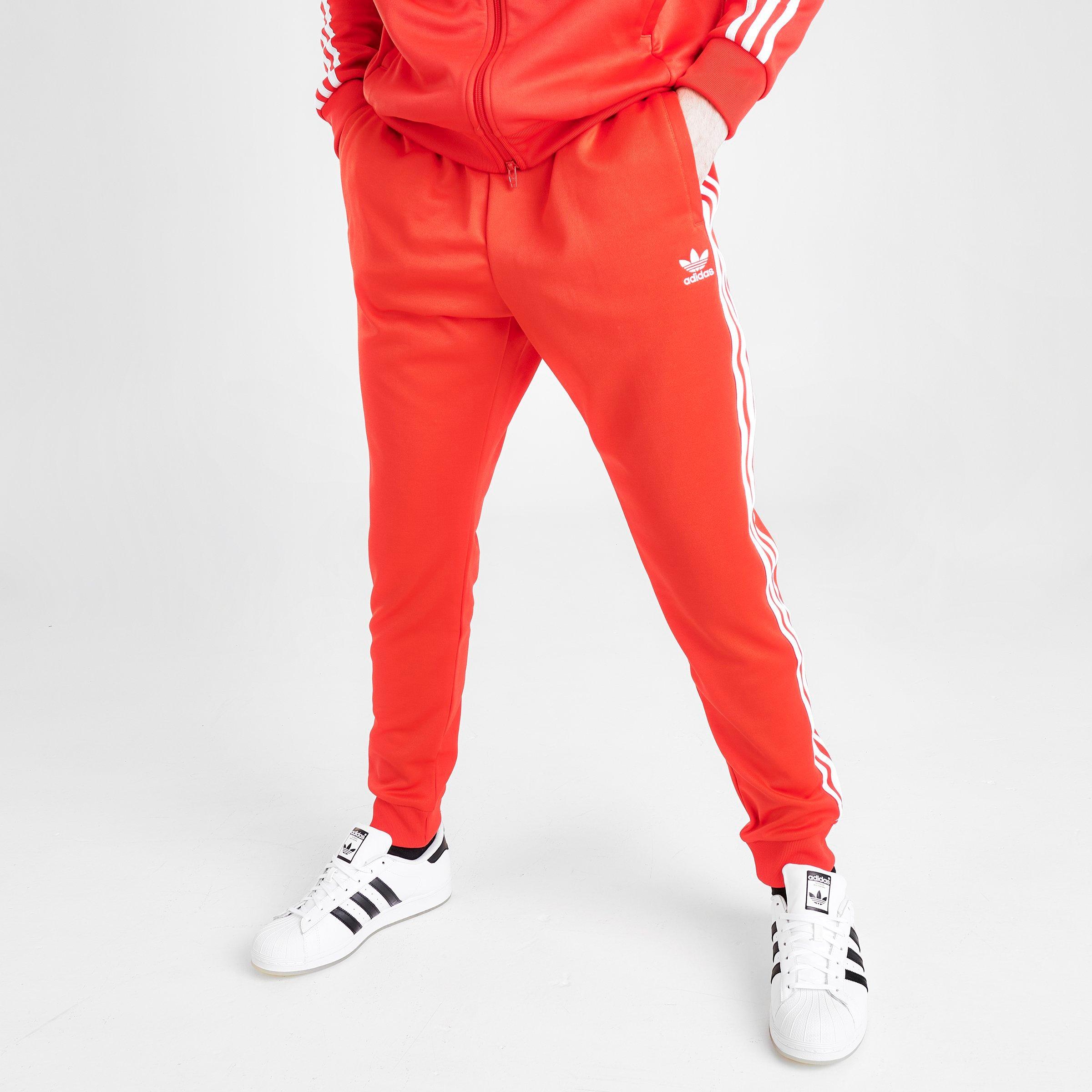 red and white adidas track pants