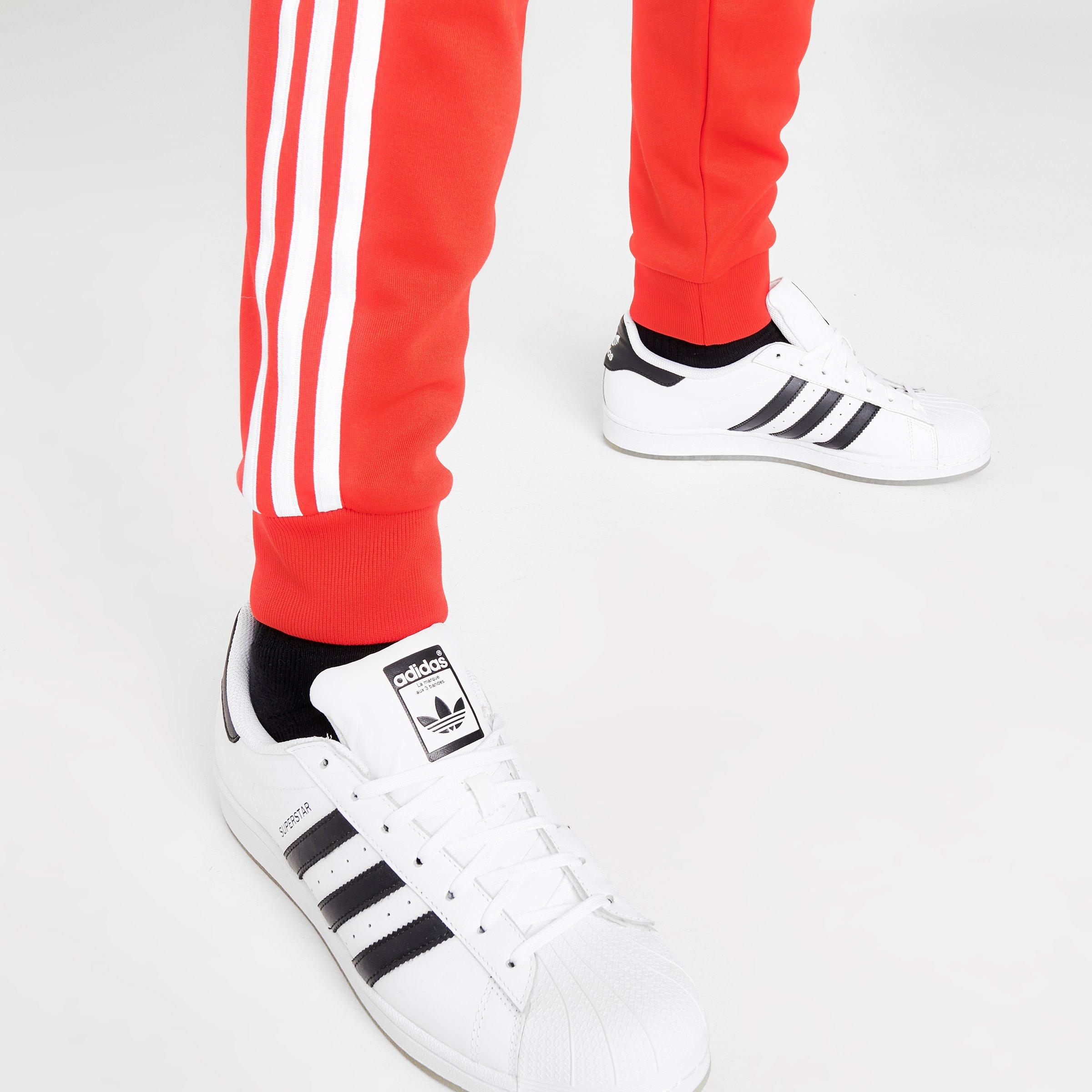 white and red adidas track pants