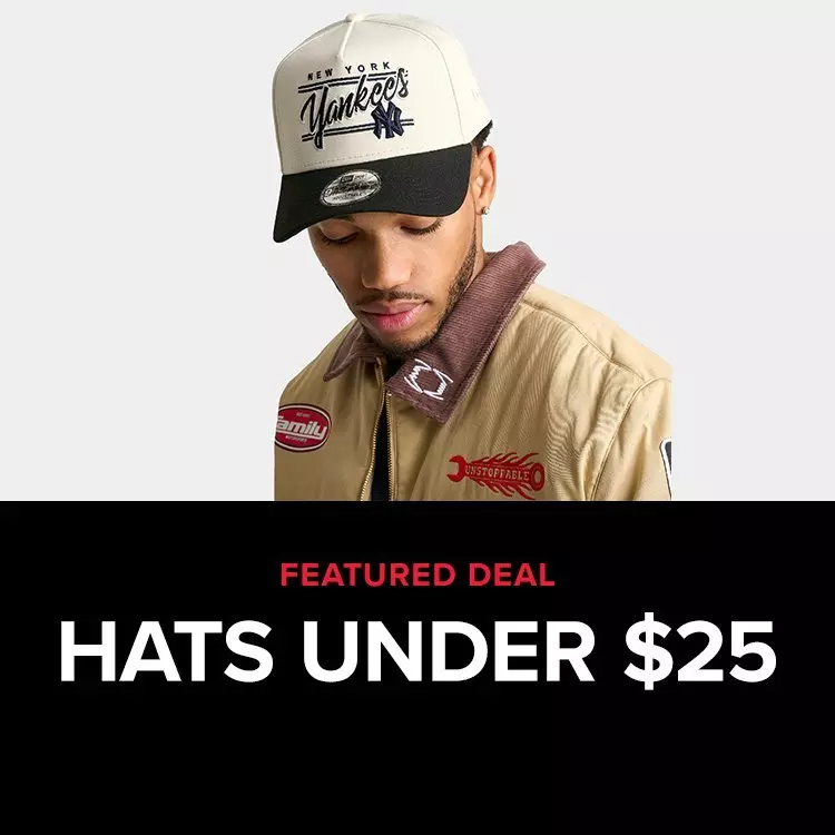 A man modeling a cream and black New Era New York Yankees snapback hat sits above text reading Featured Deal Hats Under $25.