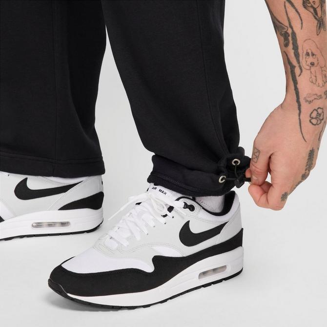 [angle] view of Men's Nike Club Fleece Bungee Sweatpants in Black/Black/White Click to zoom