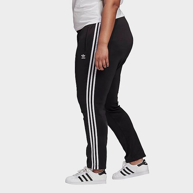 Front Three Quarter view of Women's adidas Originals Primeblue SST Track Pants (Plus Size) in Black Click to zoom