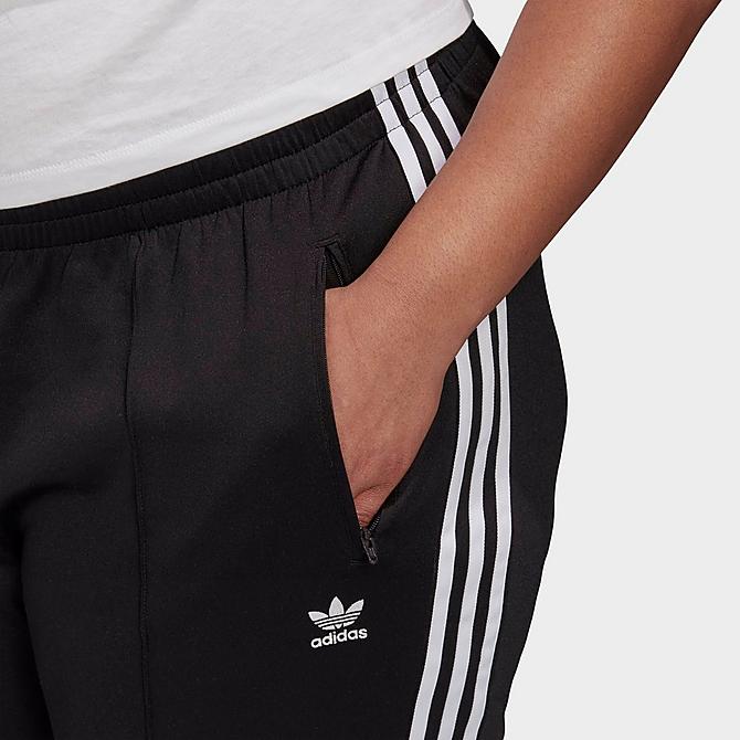 On Model 5 view of Women's adidas Originals Primeblue SST Track Pants (Plus Size) in Black Click to zoom