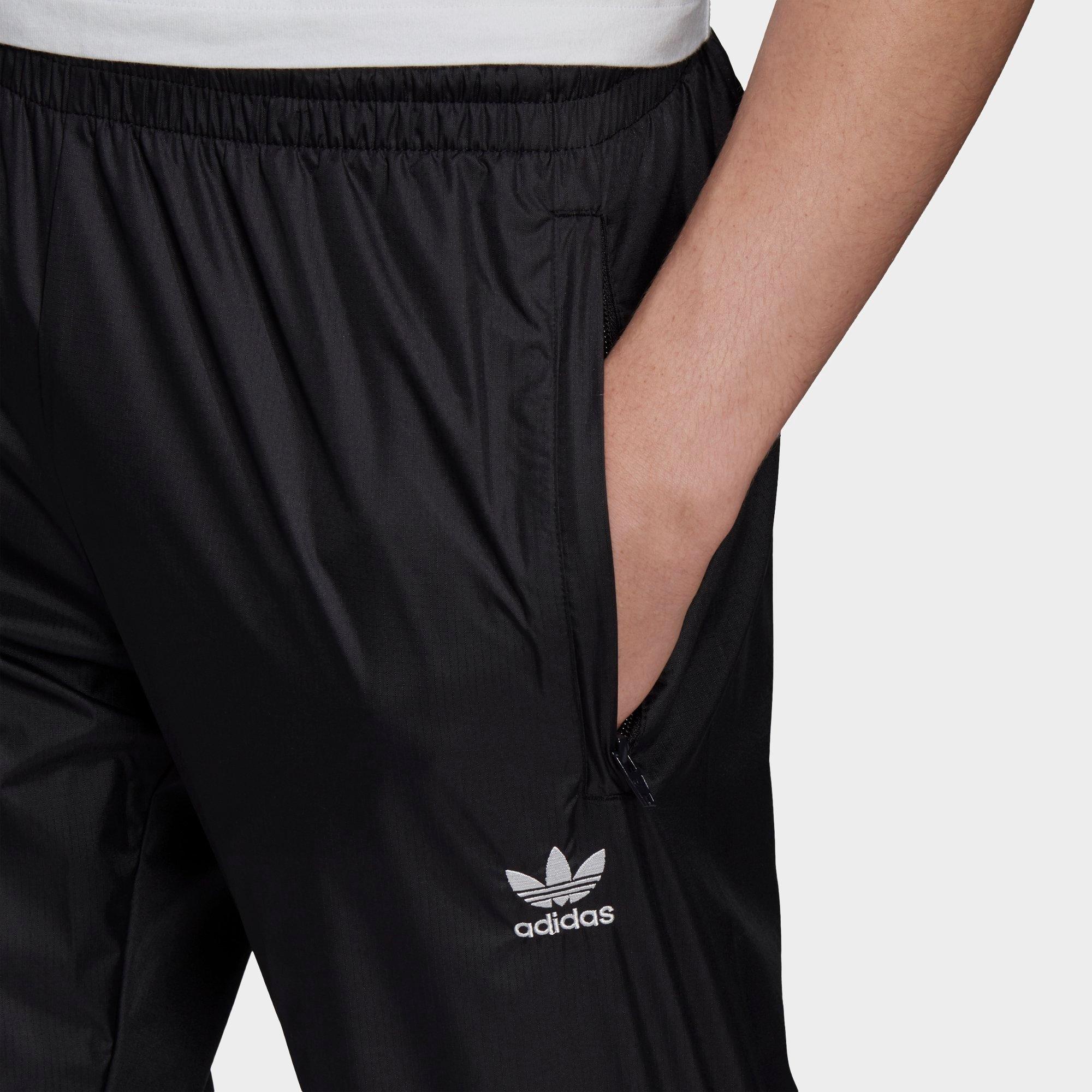 half striped adidas pants