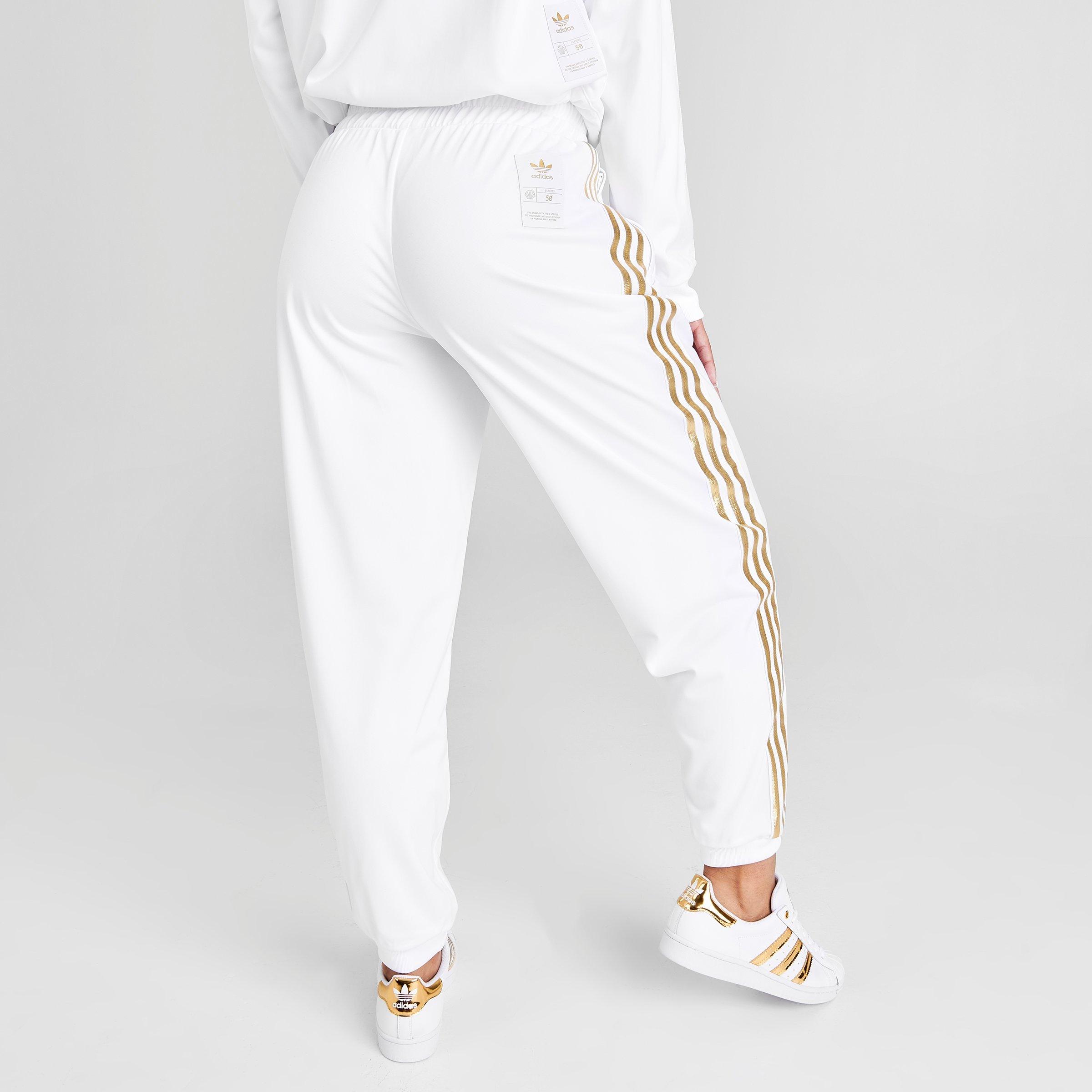 white and gold adidas track pants