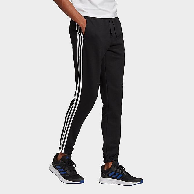 Front view of Men's adidas Essentials Fleece Tapered Elastic Cuff 3-Stripes Pants in Black Click to zoom