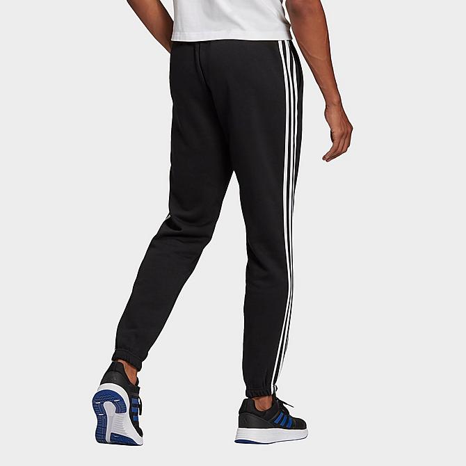 Front Three Quarter view of Men's adidas Essentials Fleece Tapered Elastic Cuff 3-Stripes Pants in Black Click to zoom