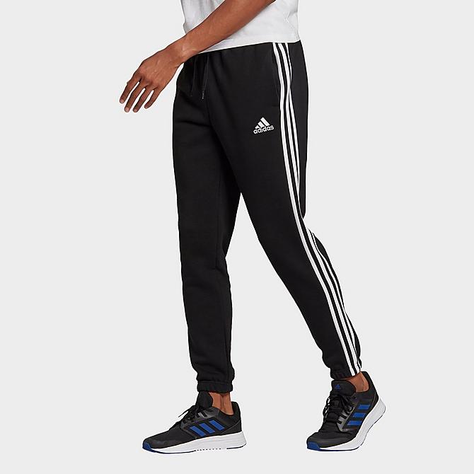 Back Left view of Men's adidas Essentials Fleece Tapered Elastic Cuff 3-Stripes Pants in Black Click to zoom