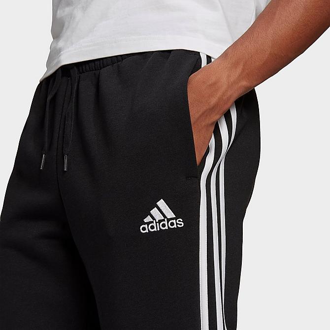 Back Right view of Men's adidas Essentials Fleece Tapered Elastic Cuff 3-Stripes Pants in Black Click to zoom
