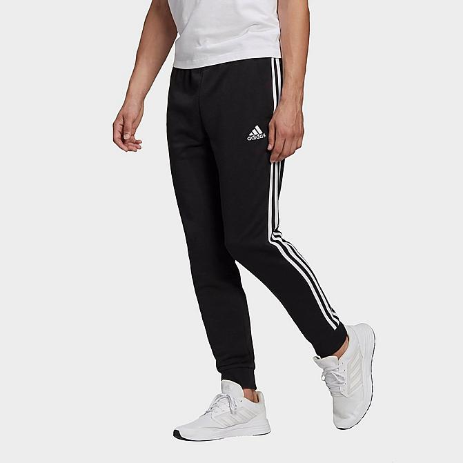 Front view of Men's adidas Essentials French Terry Tapered Cuff 3-Stripes Pants in Black/White Click to zoom
