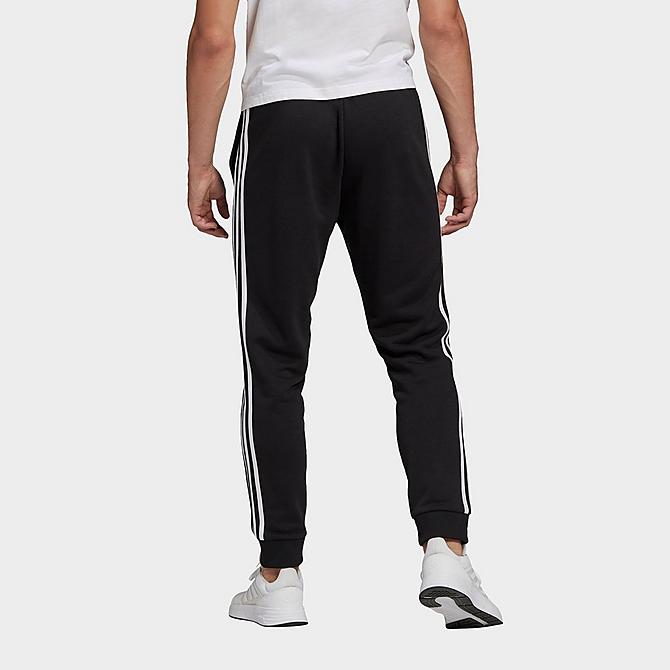 Back Left view of Men's adidas Essentials French Terry Tapered Cuff 3-Stripes Pants in Black/White Click to zoom