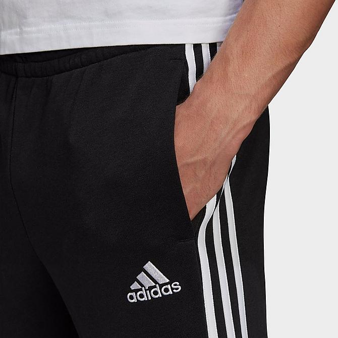Back Right view of Men's adidas Essentials French Terry Tapered Cuff 3-Stripes Pants in Black/White Click to zoom