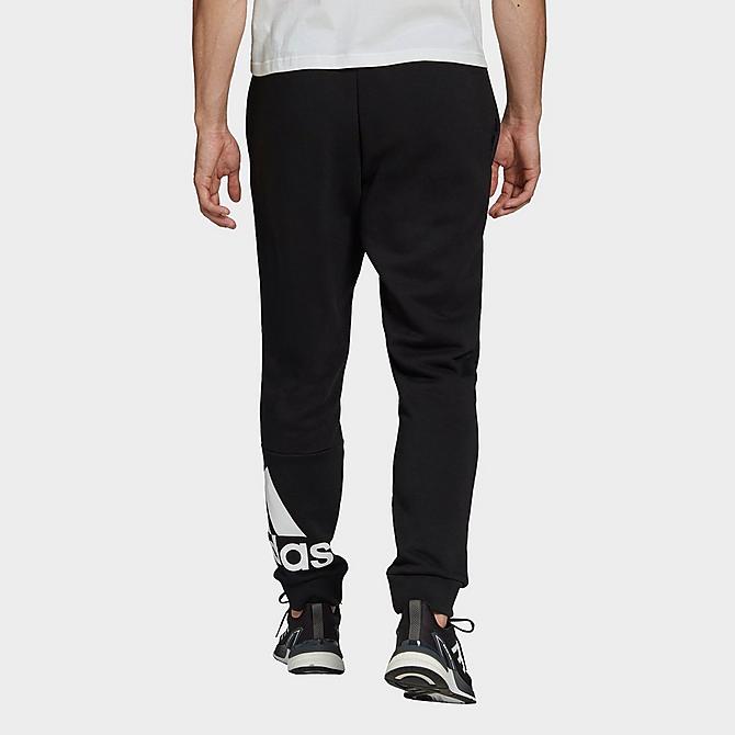 Back Left view of Men's adidas Essentials Tapered Cuff Logo Fleece Pants in Black/White Click to zoom