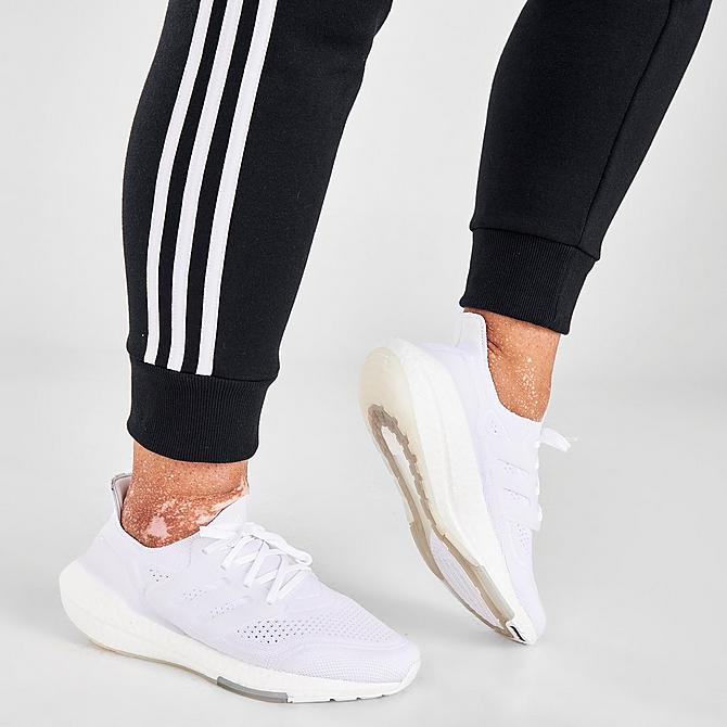 On Model 6 view of Women's adidas Essentials 3-Stripes Fleece Jogger Pants (Plus Size) in Black/White Click to zoom