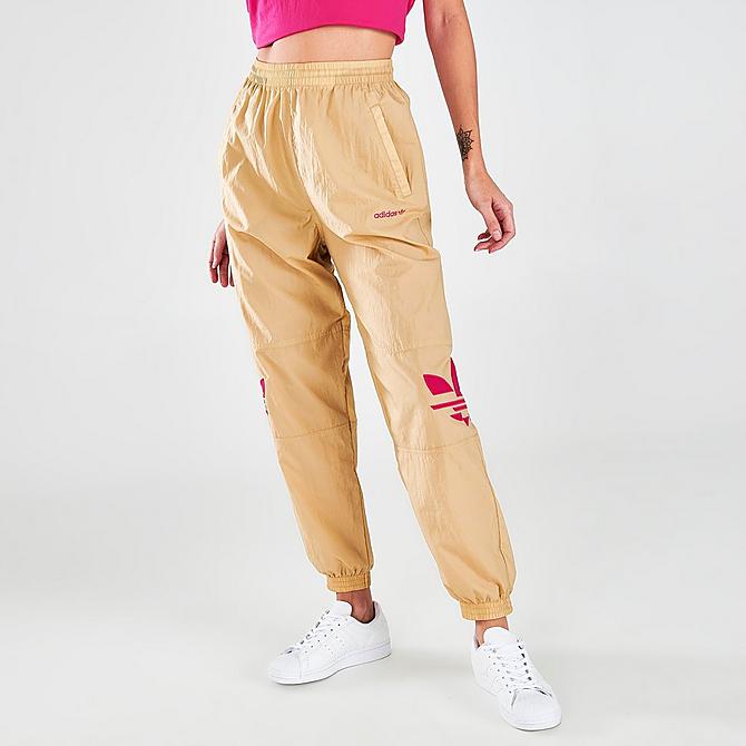 Front Three Quarter view of Women's adidas Originals Adicolor Shattered Trefoil Track Pants in Beige Tone/Pink Click to zoom