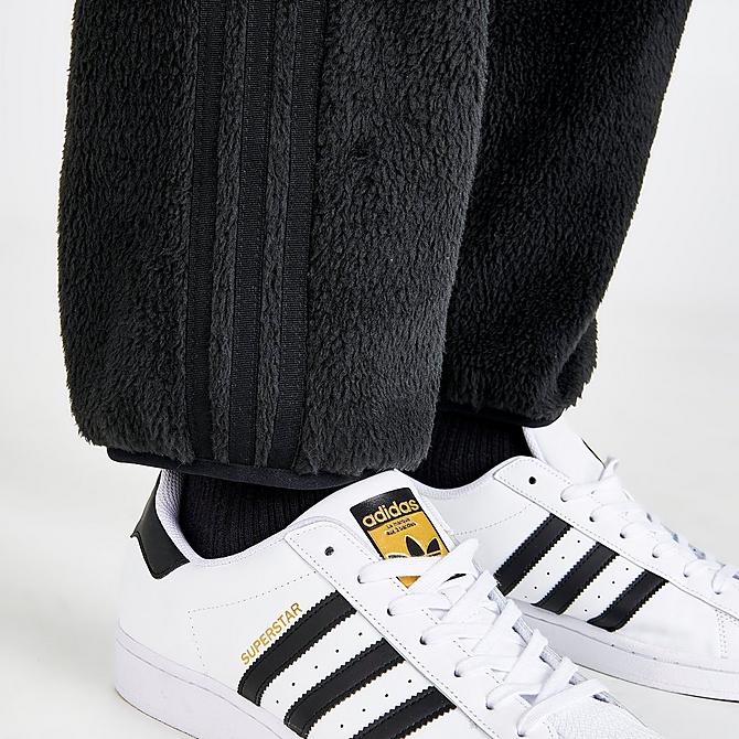 On Model 6 view of Men's adidas Originals Three Stripes Sherpa Jogger Pants in Black Click to zoom