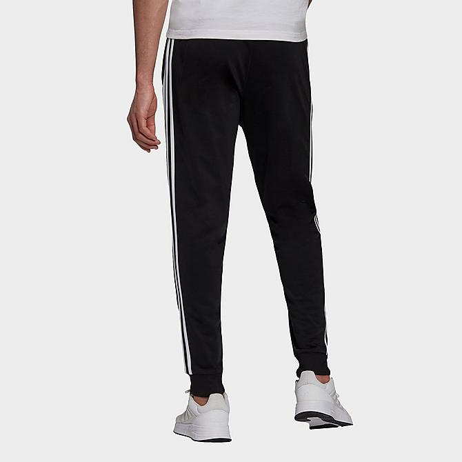 Front Three Quarter view of Men's adidas Warm-Up Tricot Tapered 3-Stripe Training Pants in Black/White Click to zoom
