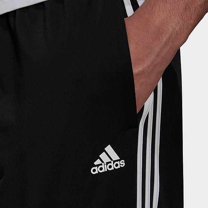 Back Right view of Men's adidas Warm-Up Tricot Tapered 3-Stripe Training Pants in Black/White Click to zoom