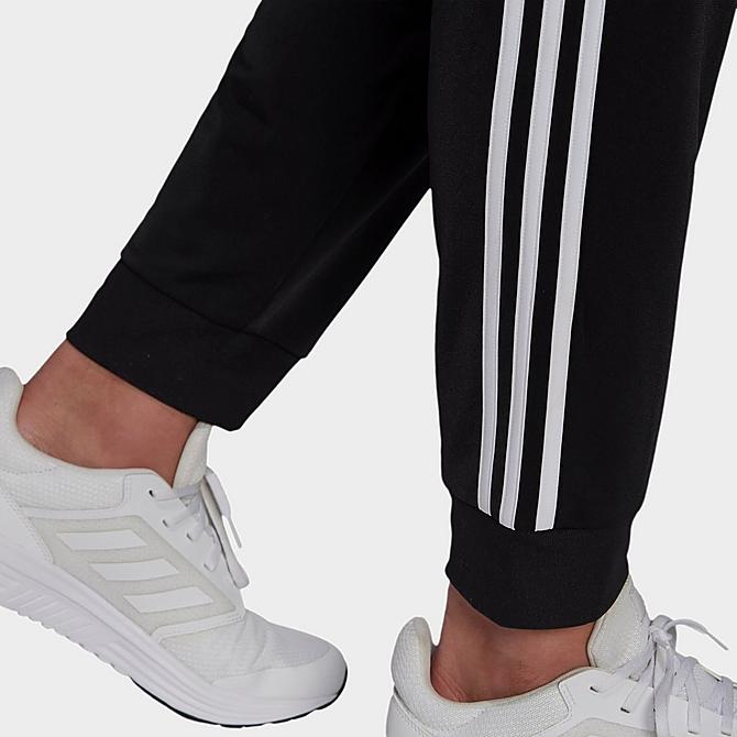 On Model 5 view of Men's adidas Warm-Up Tricot Tapered 3-Stripe Training Pants in Black/White Click to zoom