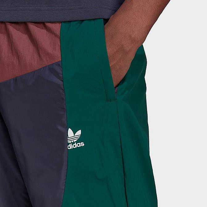 On Model 5 view of Men's adidas Originals Adicolor Colorblock Track Pants in Shadow Navy/Quiet Crimson/Collegiate Green Click to zoom