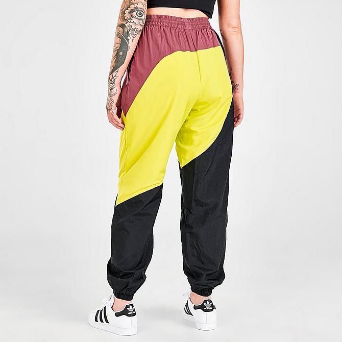Back Right view of Women's adidas Originals Adicolor Colorblocked Track Pants in Black/Shock Slime/Quiet Crimson Click to zoom