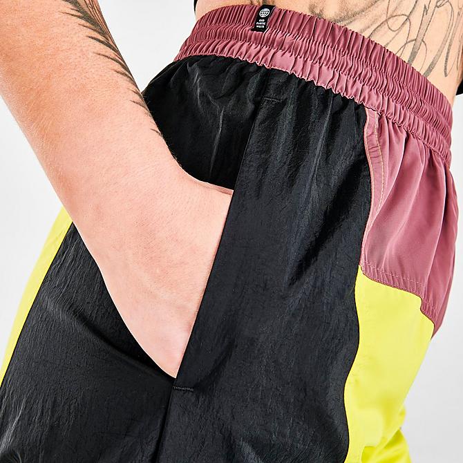 On Model 6 view of Women's adidas Originals Adicolor Colorblocked Track Pants in Black/Shock Slime/Quiet Crimson Click to zoom