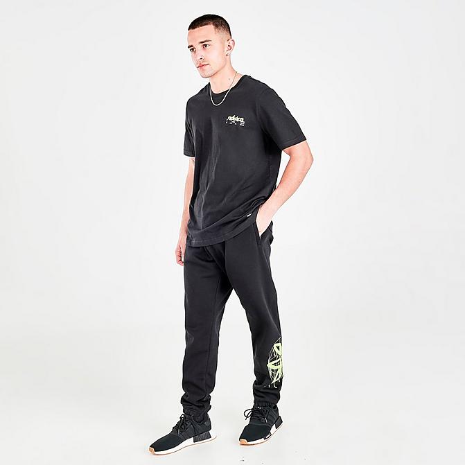 Front view of Men's adidas Originals Graphics Behind The Trefoil Jogger Pants in Black/Solar Yellow Click to zoom