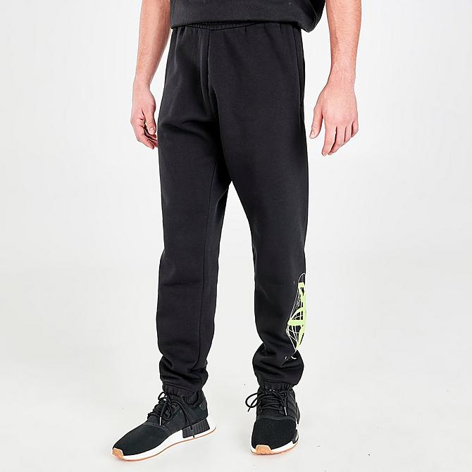 Front Three Quarter view of Men's adidas Originals Graphics Behind The Trefoil Jogger Pants in Black/Solar Yellow Click to zoom