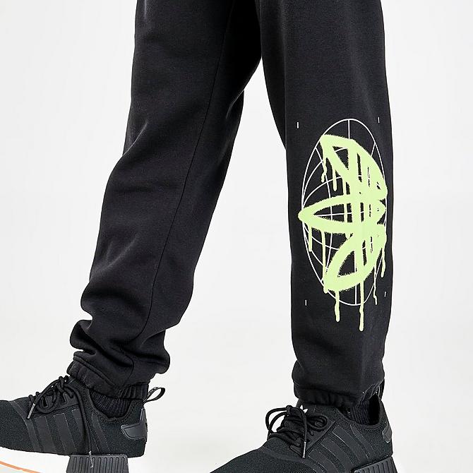 On Model 5 view of Men's adidas Originals Graphics Behind The Trefoil Jogger Pants in Black/Solar Yellow Click to zoom
