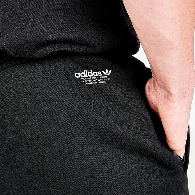 On Model 6 view of Men's adidas Originals Graphics Behind The Trefoil Jogger Pants in Black/Solar Yellow Click to zoom
