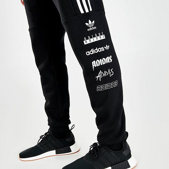 On Model 6 view of Men's adidas Originals Sticker Pack Jogger Pants in Black Click to zoom