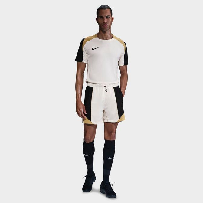 [angle] view of Men's Nike Strike+ Dri-FIT 5" Soccer Shorts in Pale Ivory/Black/Jersey Gold/Black Click to zoom