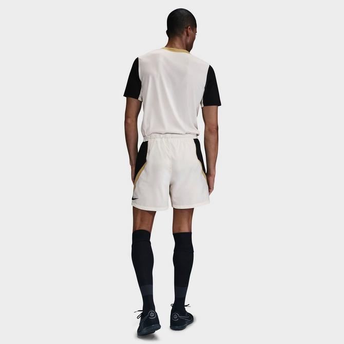 [angle] view of Men's Nike Strike+ Dri-FIT 5" Soccer Shorts in Pale Ivory/Black/Jersey Gold/Black Click to zoom