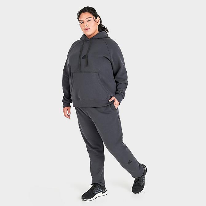 Front Three Quarter view of Women's adidas New Sportswear Logo Fleece Jogger Pants (Plus Size) in Carbon Click to zoom