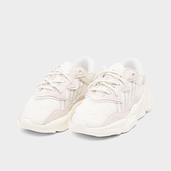 Three Quarter view of Boys' Toddler adidas Ozweego Athletic Casual Shoes in Off White/Silver Metallic/Off White Click to zoom