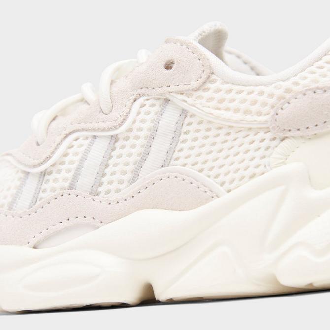 Front view of Boys' Toddler adidas Ozweego Athletic Casual Shoes in Off White/Silver Metallic/Off White Click to zoom