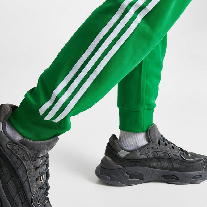 Green and white discount adidas track pants