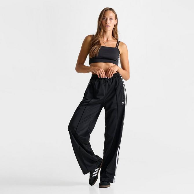 [angle] view of Women's adidas Originals Firebird Loose Track Pants in Black Click to zoom
