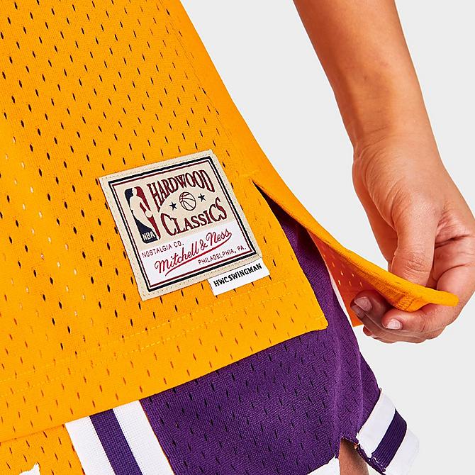 On Model 6 view of Women's Mitchell & Ness Los Angeles Lakers NBA Magic Johnson Hardwood Classics 1984-85 Swingman Jersey in Gold Click to zoom