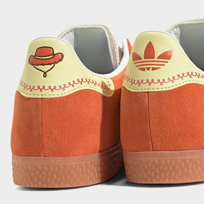 Left view of Big Kids' adidas Originals x Toy Story Gazelle R Casual Shoes in Orange/White/Gum Click to zoom