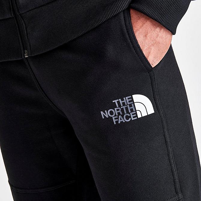 On Model 5 view of Men's The North Face Linear Graphic Track Pants in Black Click to zoom