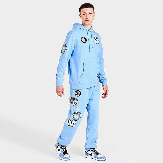 Front Three Quarter view of Men's Mitchell & Ness University of North Carolina Tar Heels College Champs Jogger Pants in Carolina Blue Click to zoom