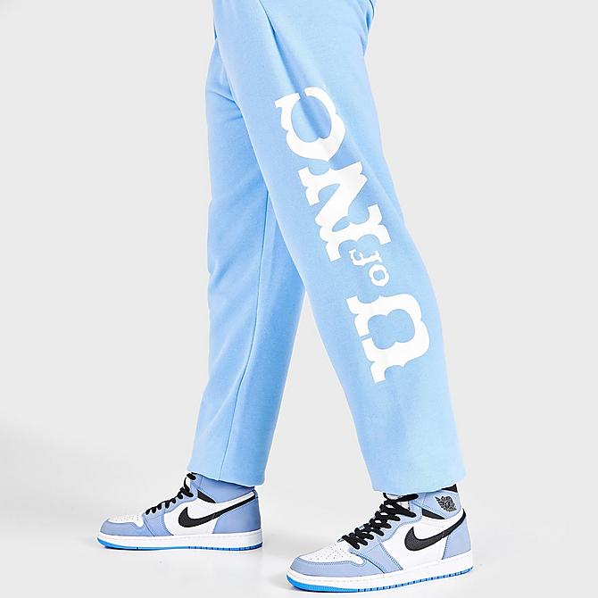 On Model 6 view of Men's Mitchell & Ness University of North Carolina Tar Heels College Champs Jogger Pants in Carolina Blue Click to zoom