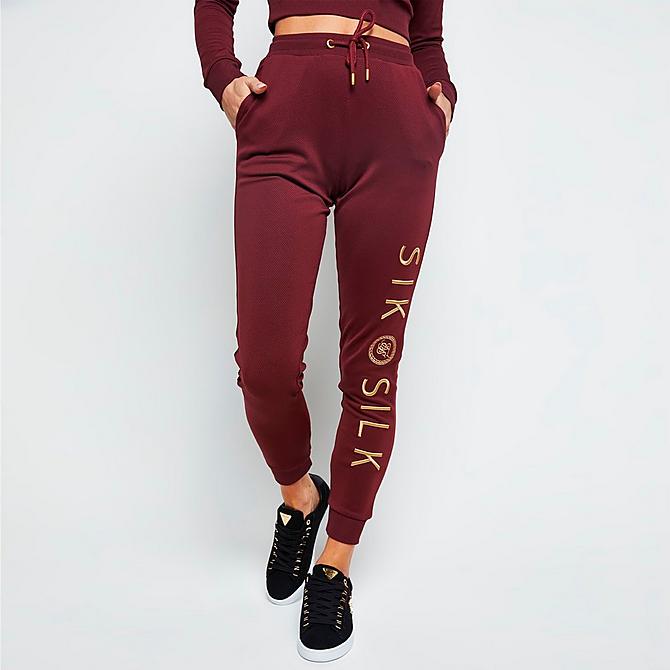 Front Three Quarter view of Women's SikSilk Eyelet Mesh Track Jogger Pants in Burgundy Click to zoom