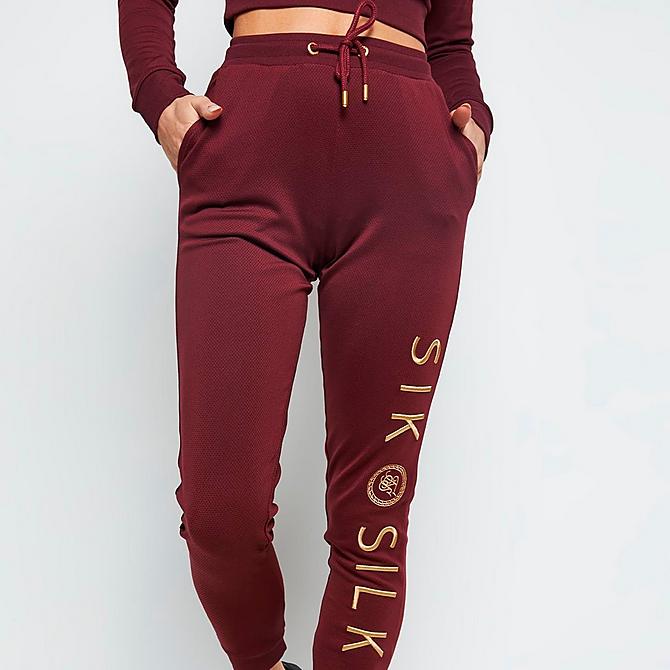 On Model 5 view of Women's SikSilk Eyelet Mesh Track Jogger Pants in Burgundy Click to zoom