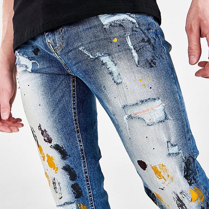 On Model 5 view of Men's Supply & Demand Paint Splatter Jeans in Indigo Click to zoom