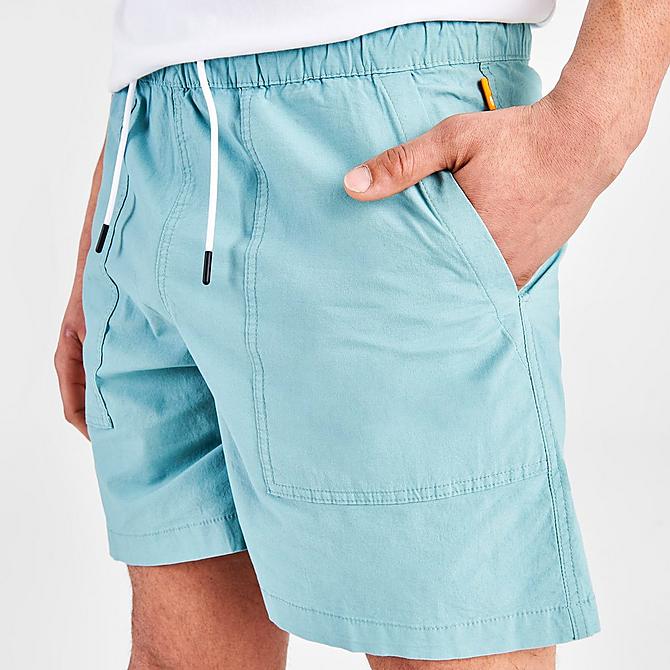 On Model 5 view of Men's Timberland Progressive Utility Shorts in Mineral Blue Click to zoom