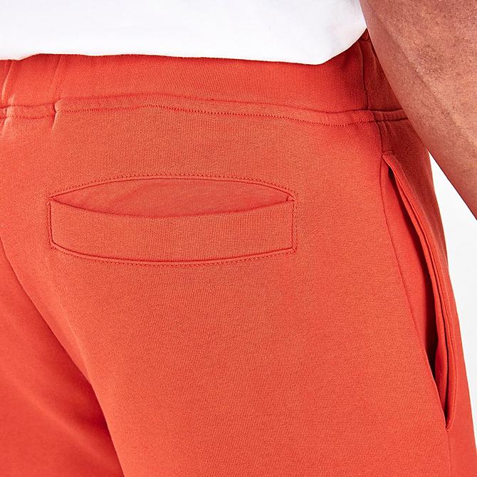 On Model 6 view of Men's Timberland Stack Logo Sweatshorts in Burnt Ochre Click to zoom