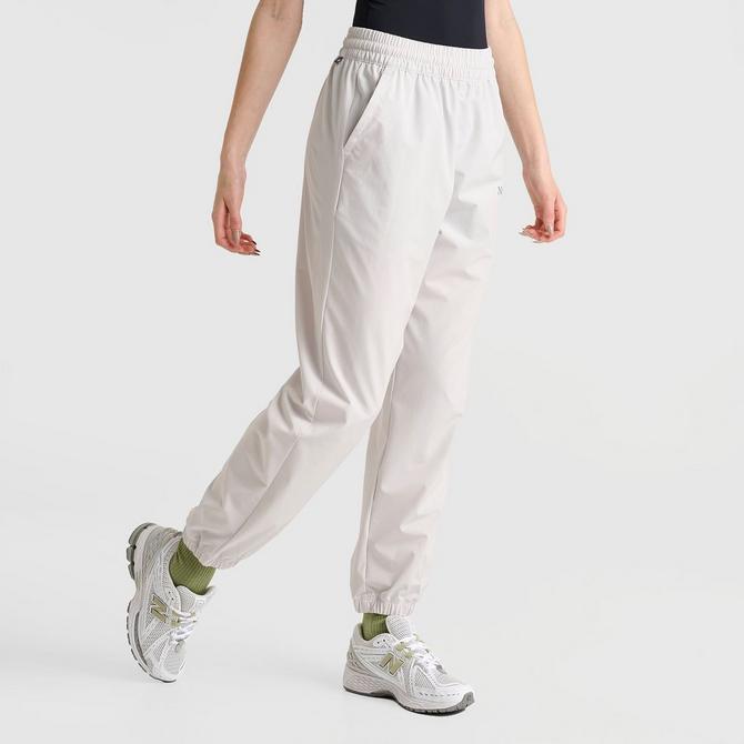 [angle] view of Women's New Balance Athletics Stretch Woven Jogger Pants in Grey Matter Click to zoom