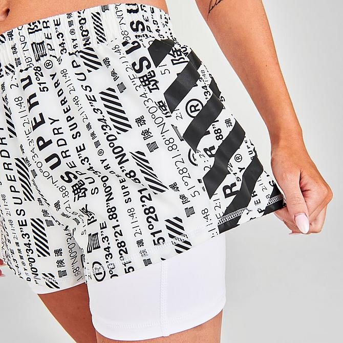 On Model 5 view of Women's Superdry Logo Running Shorts in Optic/Allover Print Click to zoom