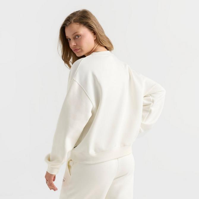 [angle] view of Women's New Balance Logo Crewneck Sweatshirt in Salt/Spruce Click to zoom
